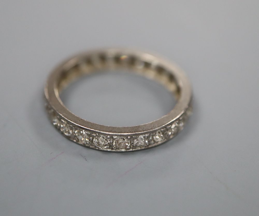 A white metal and diamond set full eternity ring, size N/O, gross 2.8 grams.
